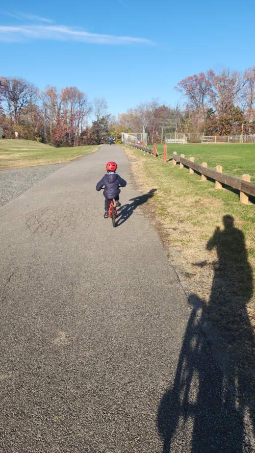 Little brother chasing big brothers on his bike